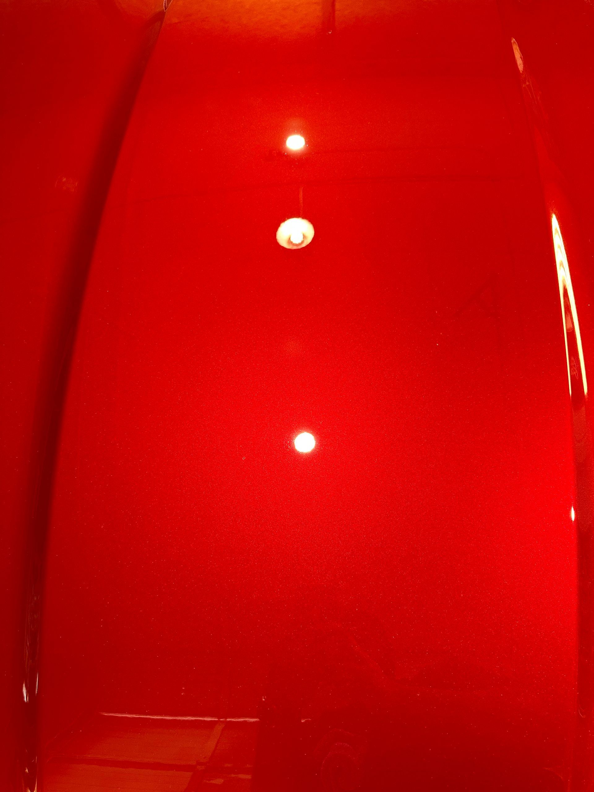 a close up of a red hood with three lights on it .