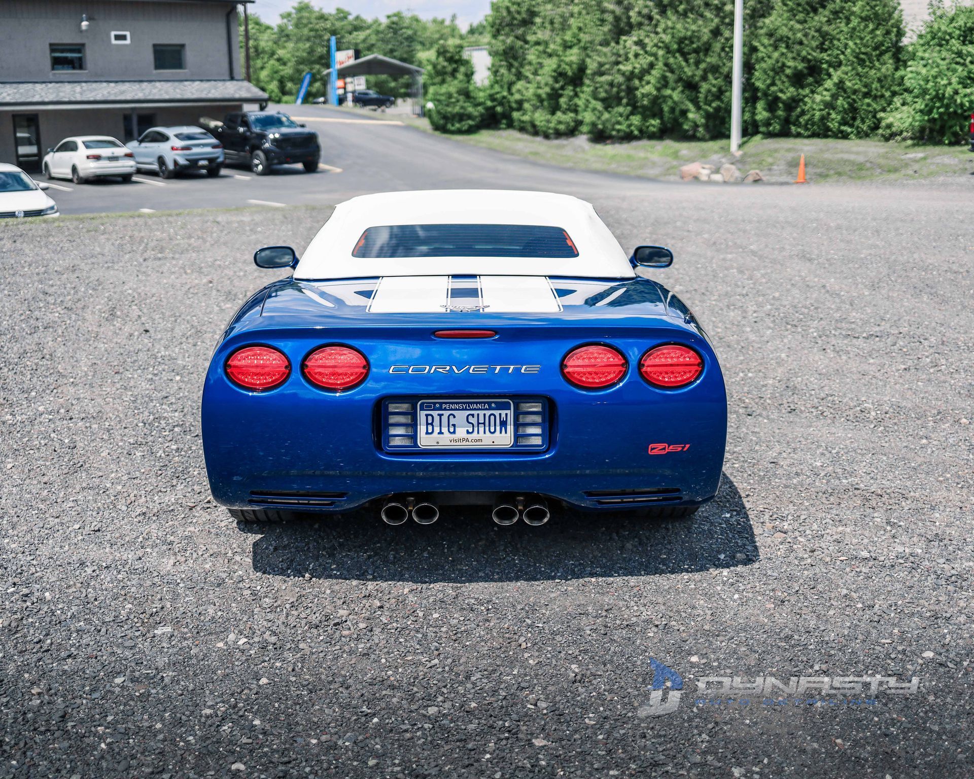 A blue corvette is parked in a parking lot