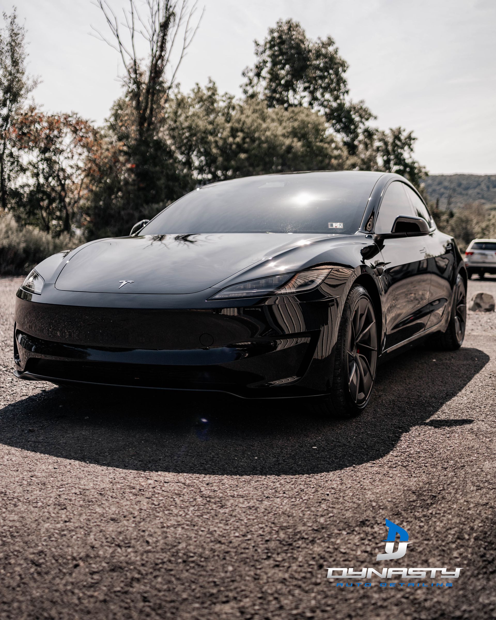 A black sports car is parked on the side of the road.