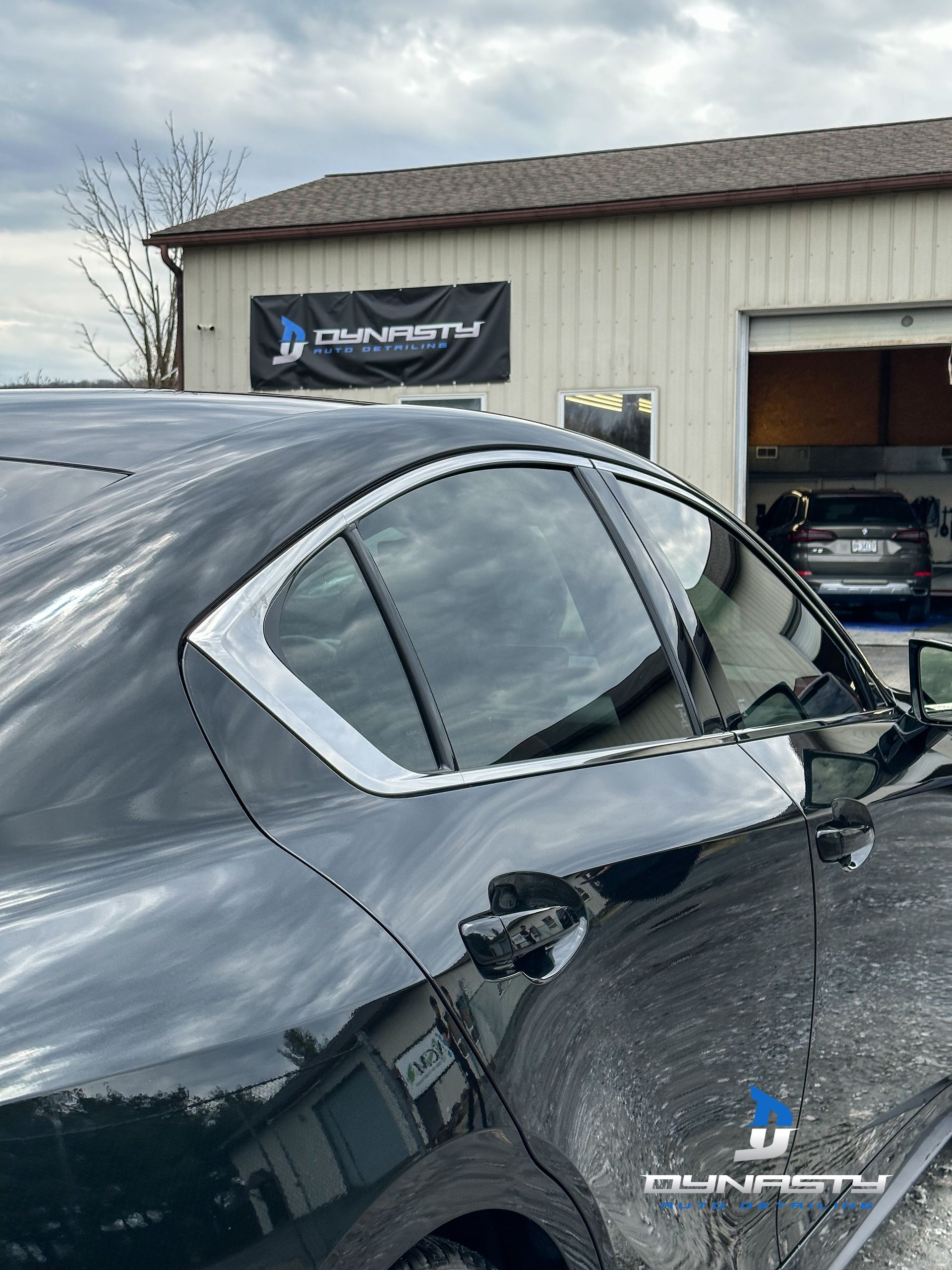 A white bmw i8 is parked in a grassy field at a car show.