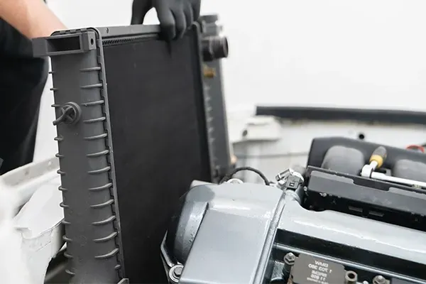 Close-up of a printer’s open black cover and internal components being adjusted by a gloved hand
