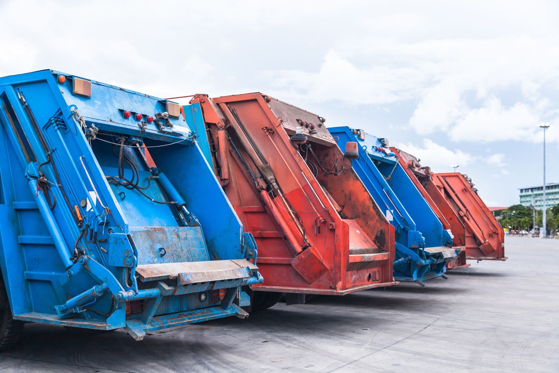 Several cars parked garbage truck for transport to garbage collection.
