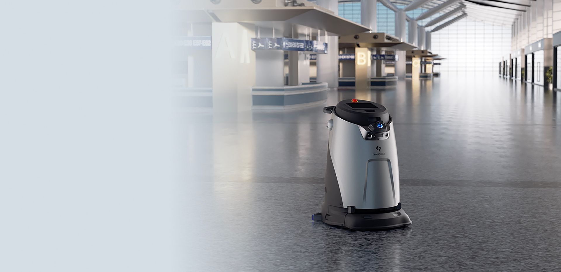 A robot is sitting in an empty warehouse.