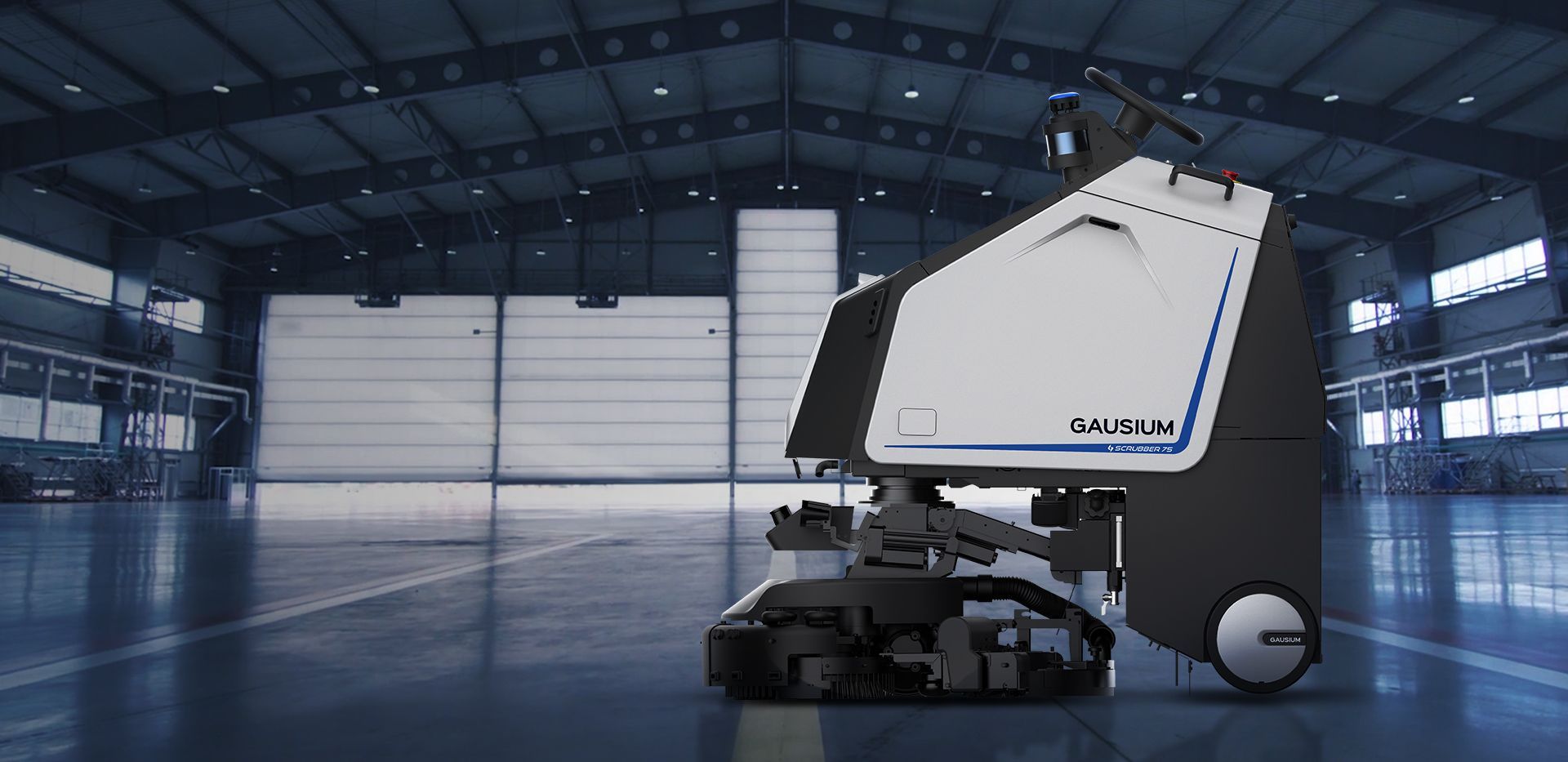 A robot is sitting in an empty warehouse.