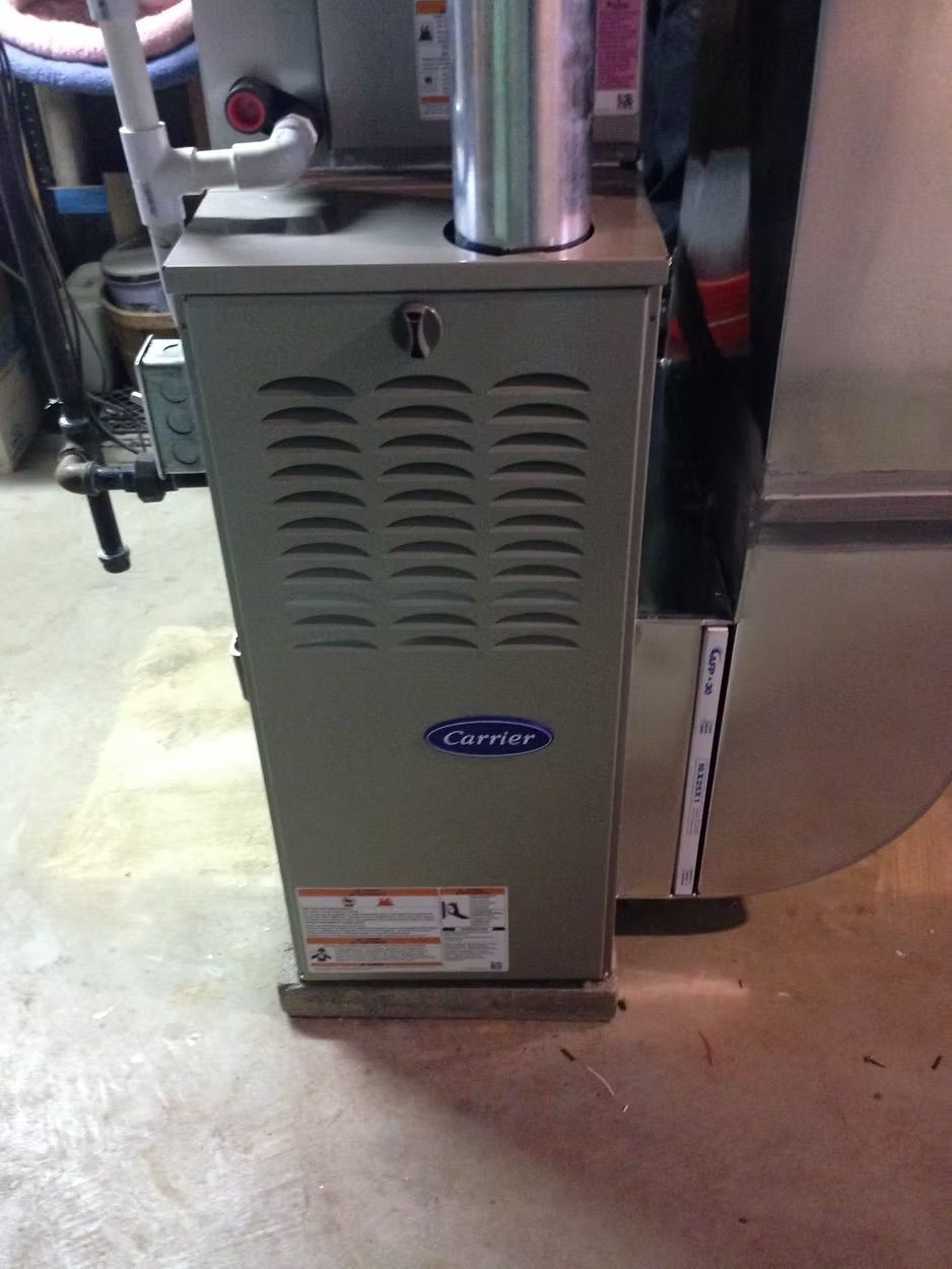 A gray Carrier furnace in a basement setting.