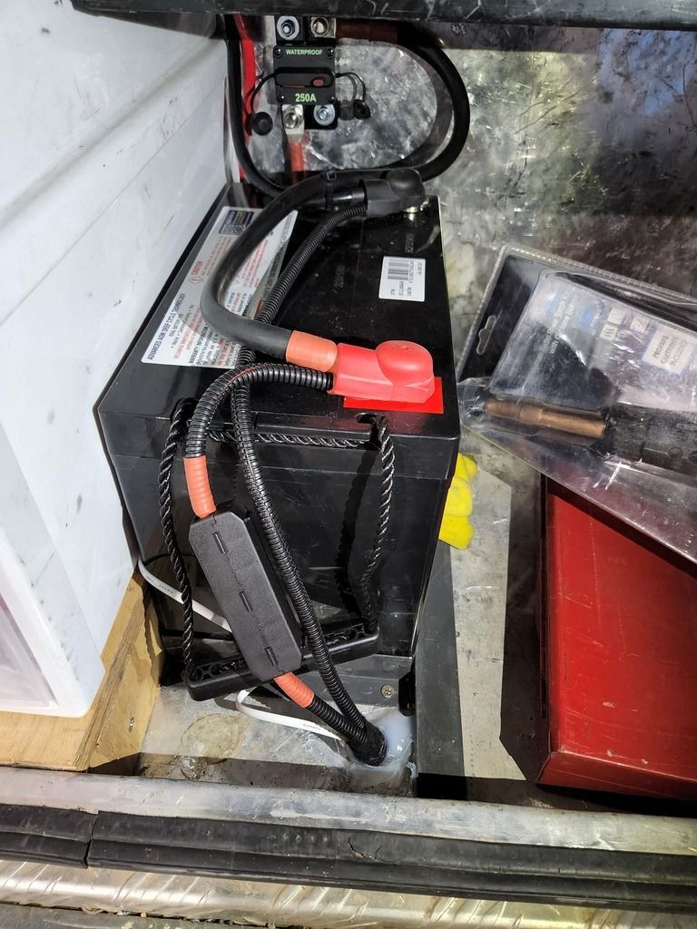 A Black Battery with Red Wires Attached to It Is Sitting on Top of A Table — Genesis Automotive Services in Lavington, NSW
