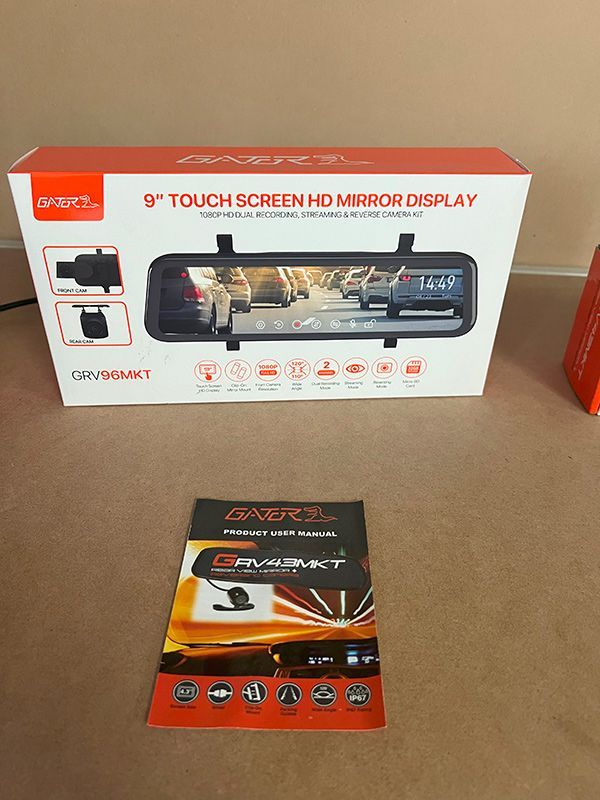 A Car Rear View Mirror Is Sitting on A Table Next to A Box — Genesis Automotive Services in Lavington, NSW