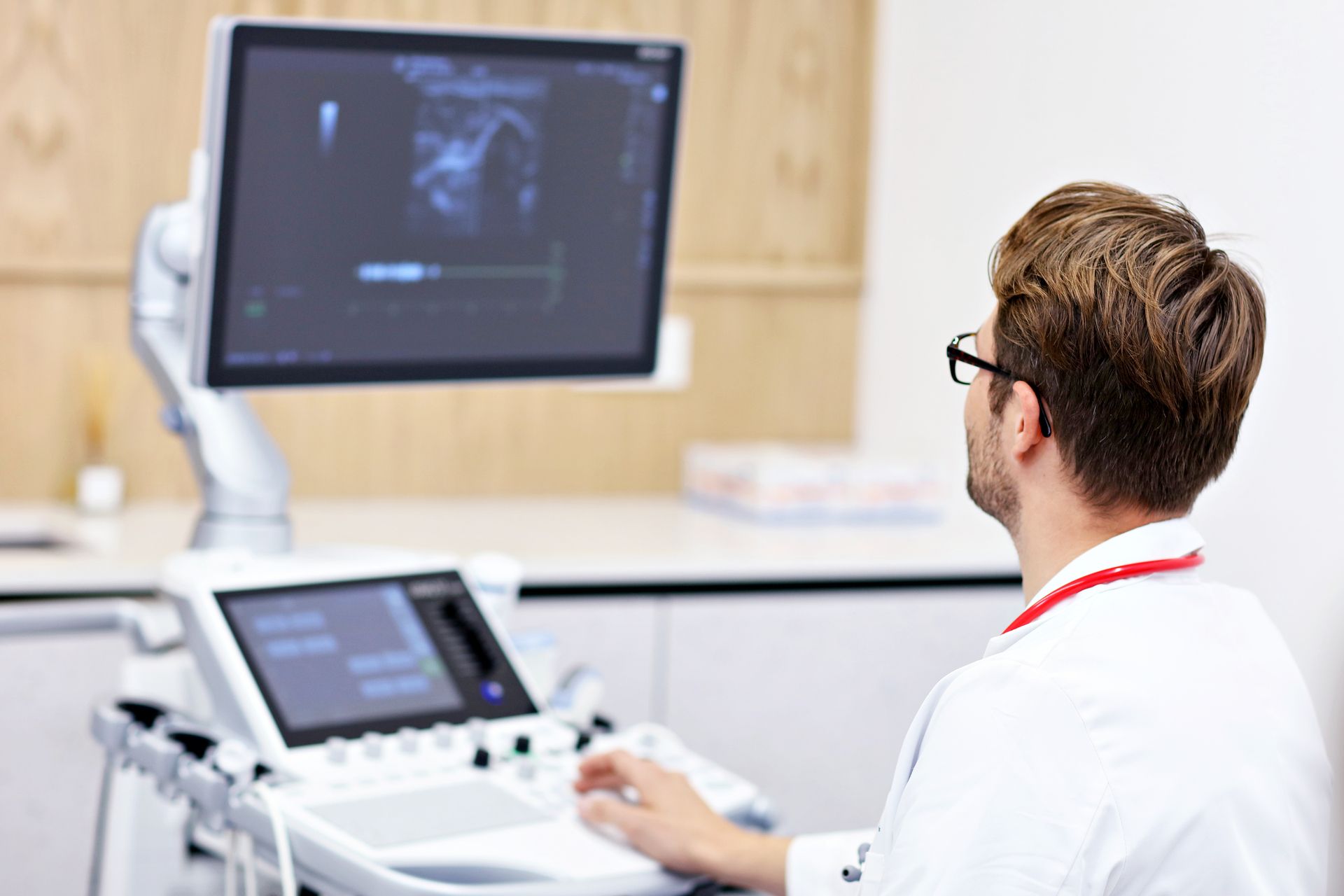 ultrasound technician using an ultrasound machine