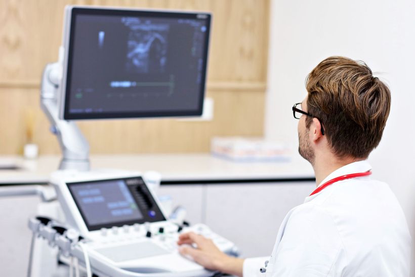 ultrasound technician using an ultrasound machine