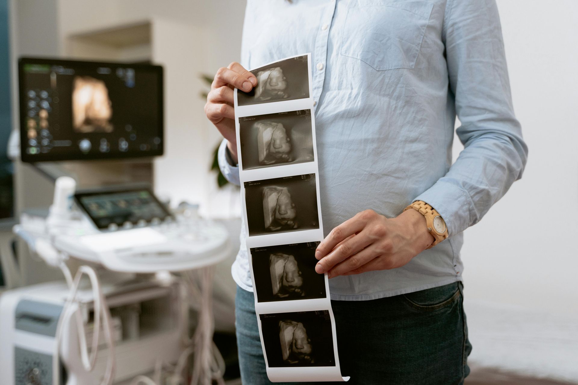 a man holding a collection of ultrasound images 