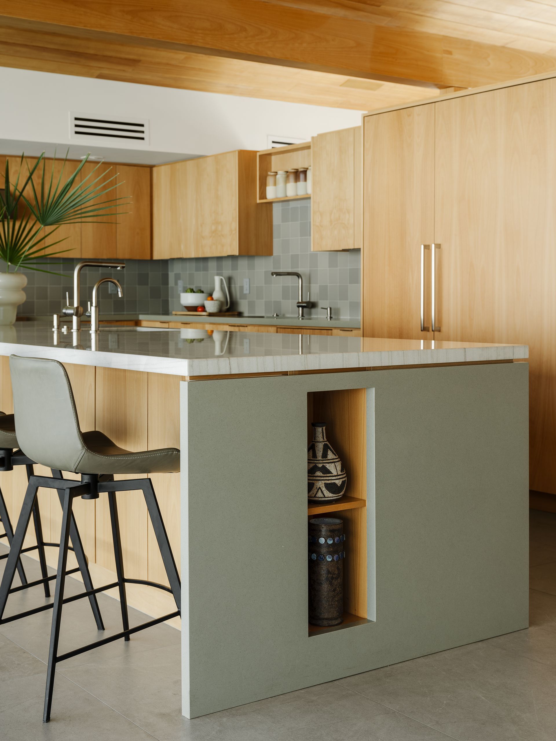 a kitchen with a large island and stools