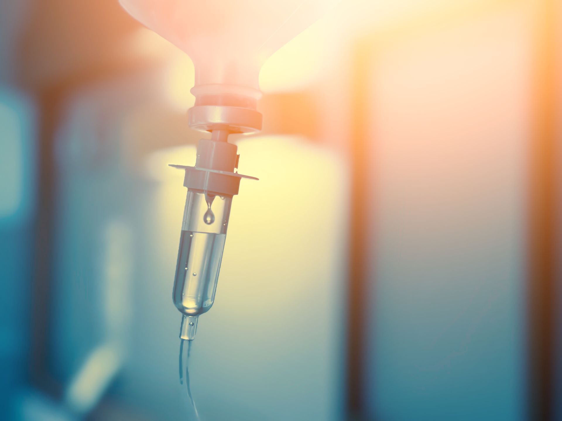 IV drip with fluid drops, in a hospital setting.