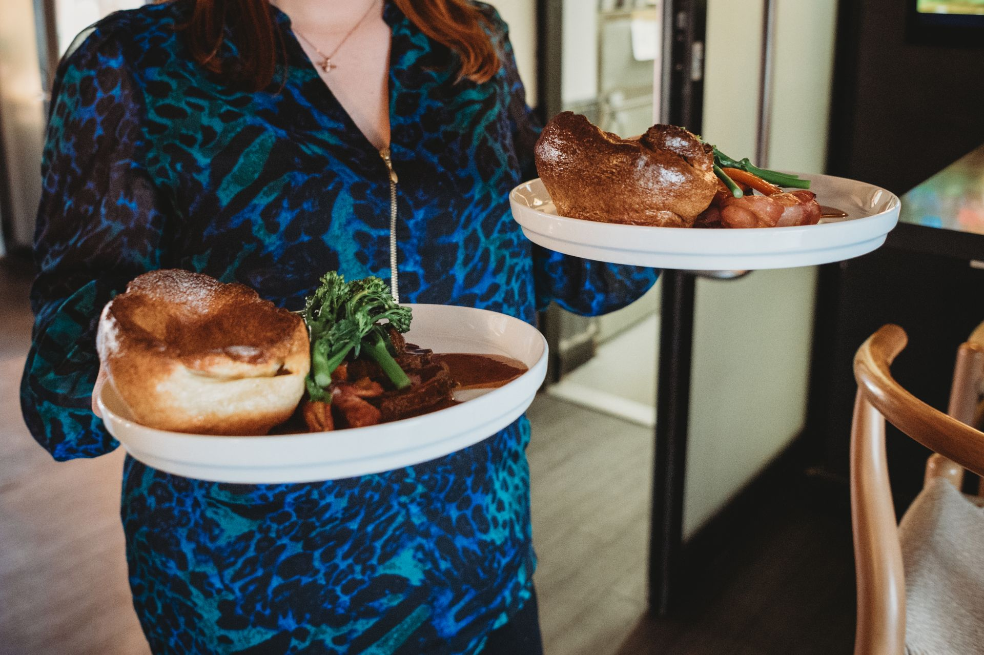 Person holding two plates of roast beef with Yorkshire pudding and vegetables. at the Boot & Shoe Waterfoot, Rossendale
