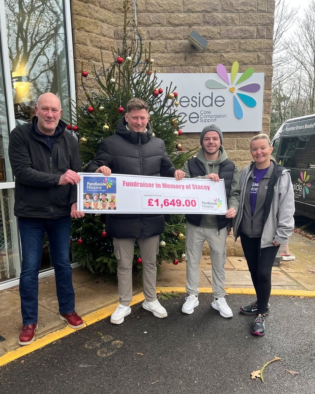Four people holding large check for £1,649.00. Money raised for Pendleside Hospice - supported by the Boot & Shoe Waterfoot