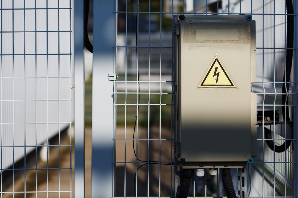 Gray Metal Electrical Box With a High Voltage Warning Symbol — CKS Electrical and Air Conditioning in Ciccone, NT