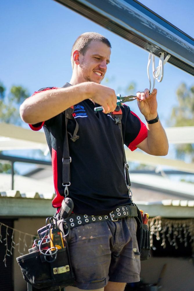 Man in a Work Shirt With a Tool Belt — CKS Electrical and Air Conditioning in Ciccone, NT