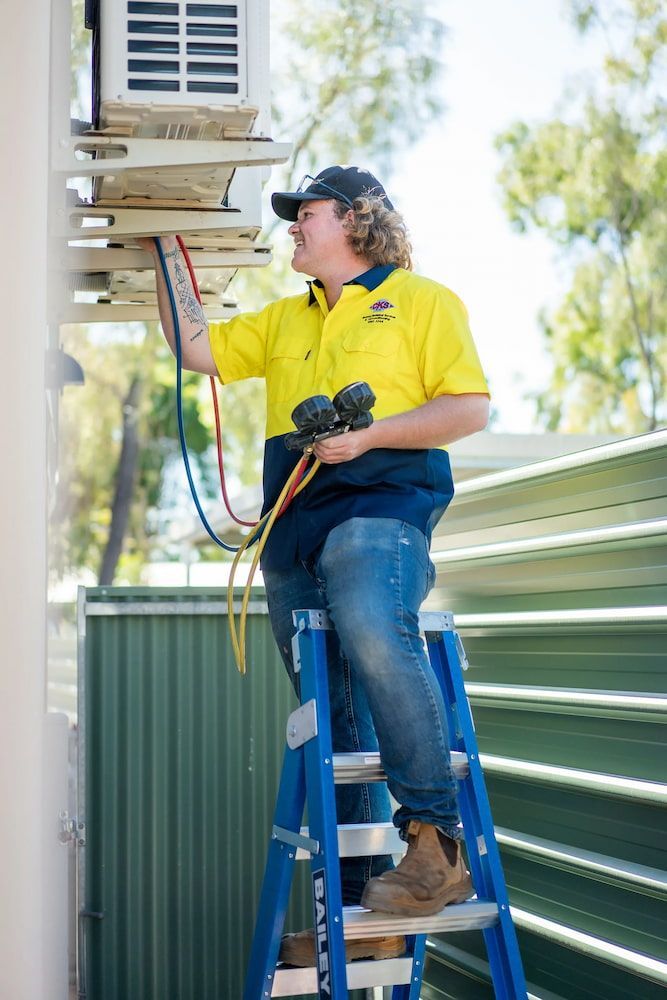 Technician Fixing Wirings on Residential House — CKS Electrical and Air Conditioning in Ciccone, NT