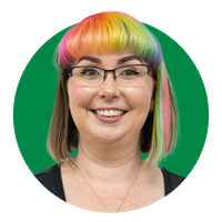 Portrait of a smiling person with rainbow hair and glasses on a green background