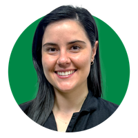 Smiling woman with dark hair against a green background