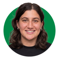 Smiling person in a black shirt against a green circular background