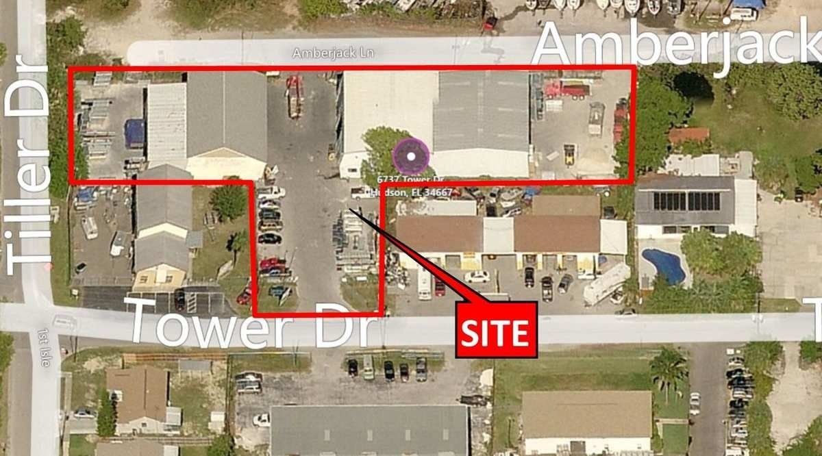 Aerial map with a red outlined property boundary and a red “SITE” arrow marking a location near Amberjack Tower.
