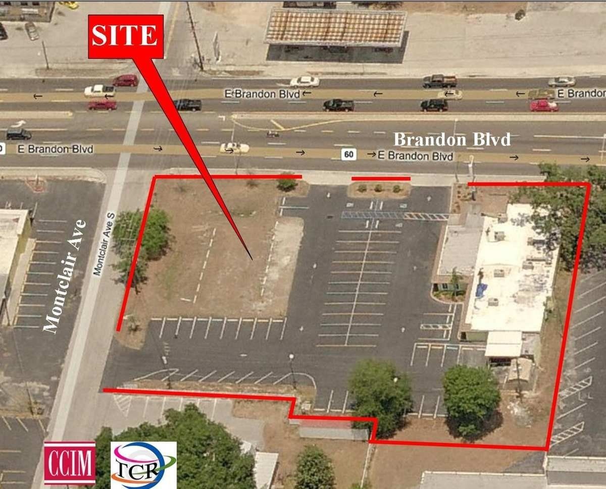 Aerial view of a commercial property site outlined in red, located off Brandon Blvd, featuring parking and a building.
