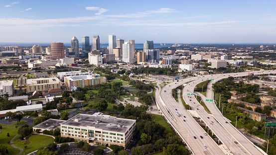 Aerial view of Tampa, Florida skyline with highway overpasses in foreground.