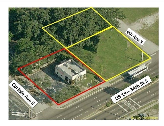 Aerial view of a building lot outlined in red and yellow along US-19 and nearby streets.
