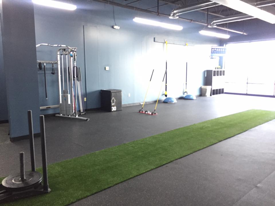 Weight training area and turf space inside Hustle & Heart Fitness personal training studio Overland Park KS