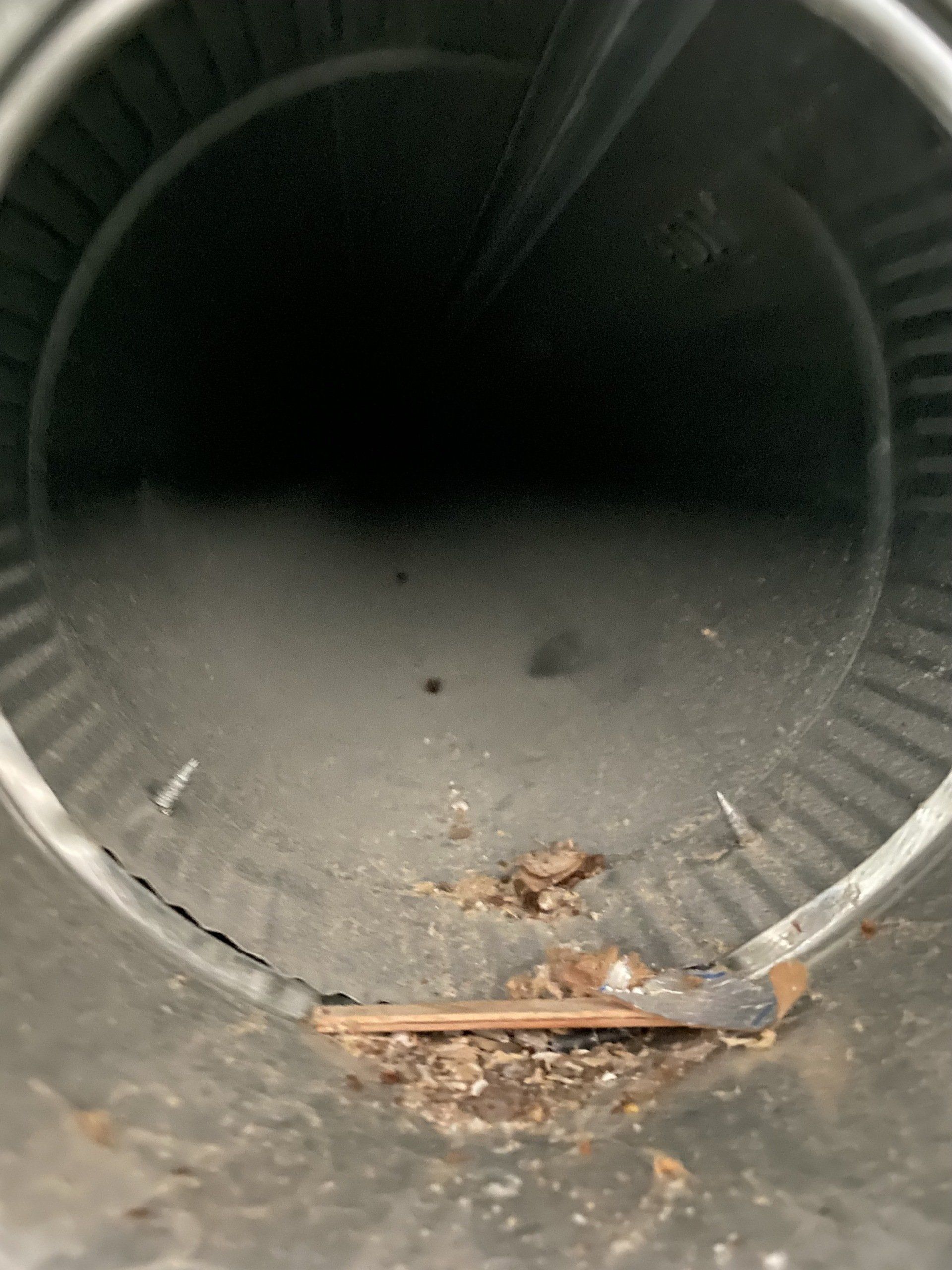 A close up of a metal pipe with a hole in it.