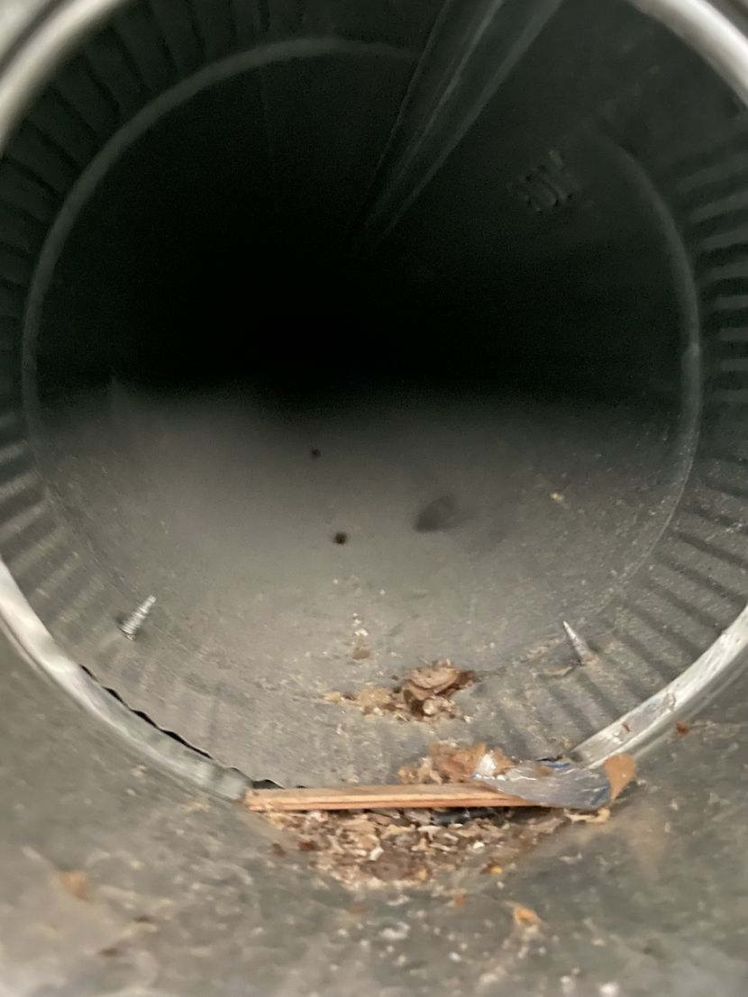 A close up of a metal pipe with a hole in it.