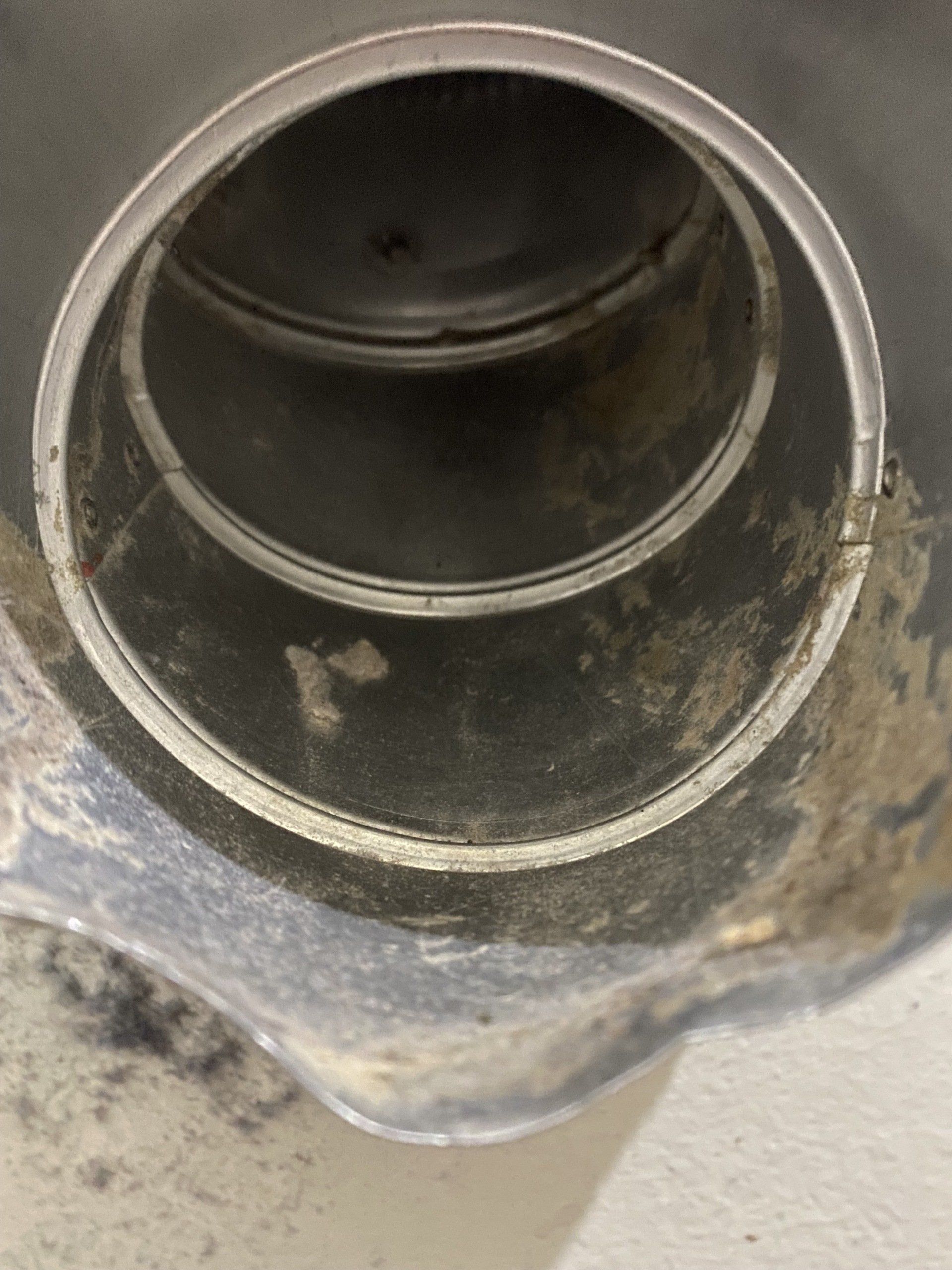 A close up of a metal pipe with a hole in it