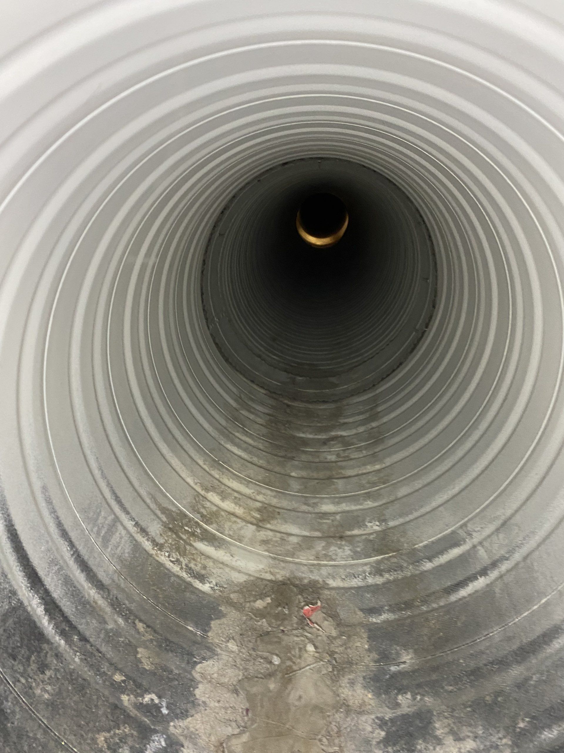 A close up of the inside of a drain pipe.