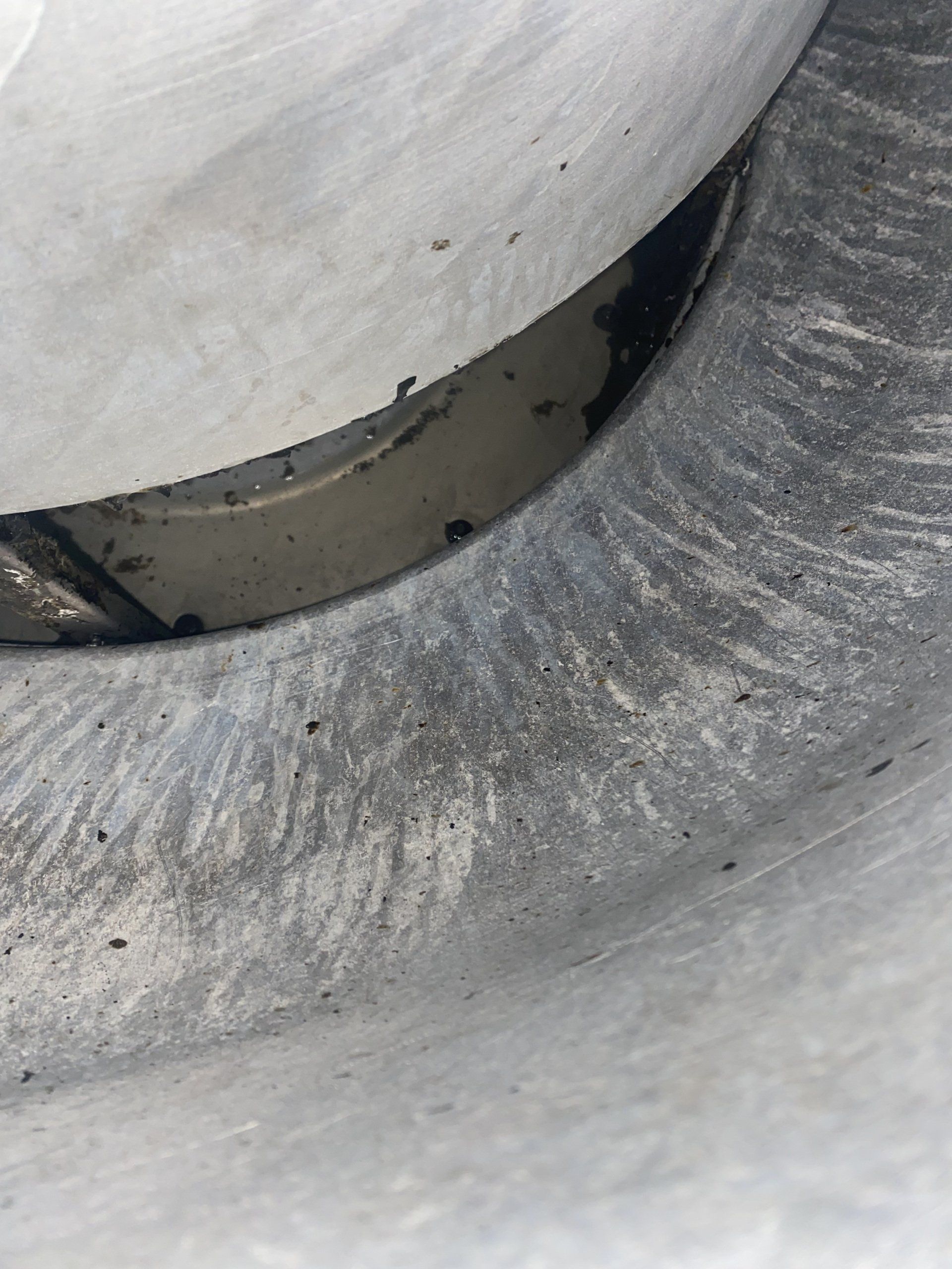 A close up of a wheel on a white surface.
