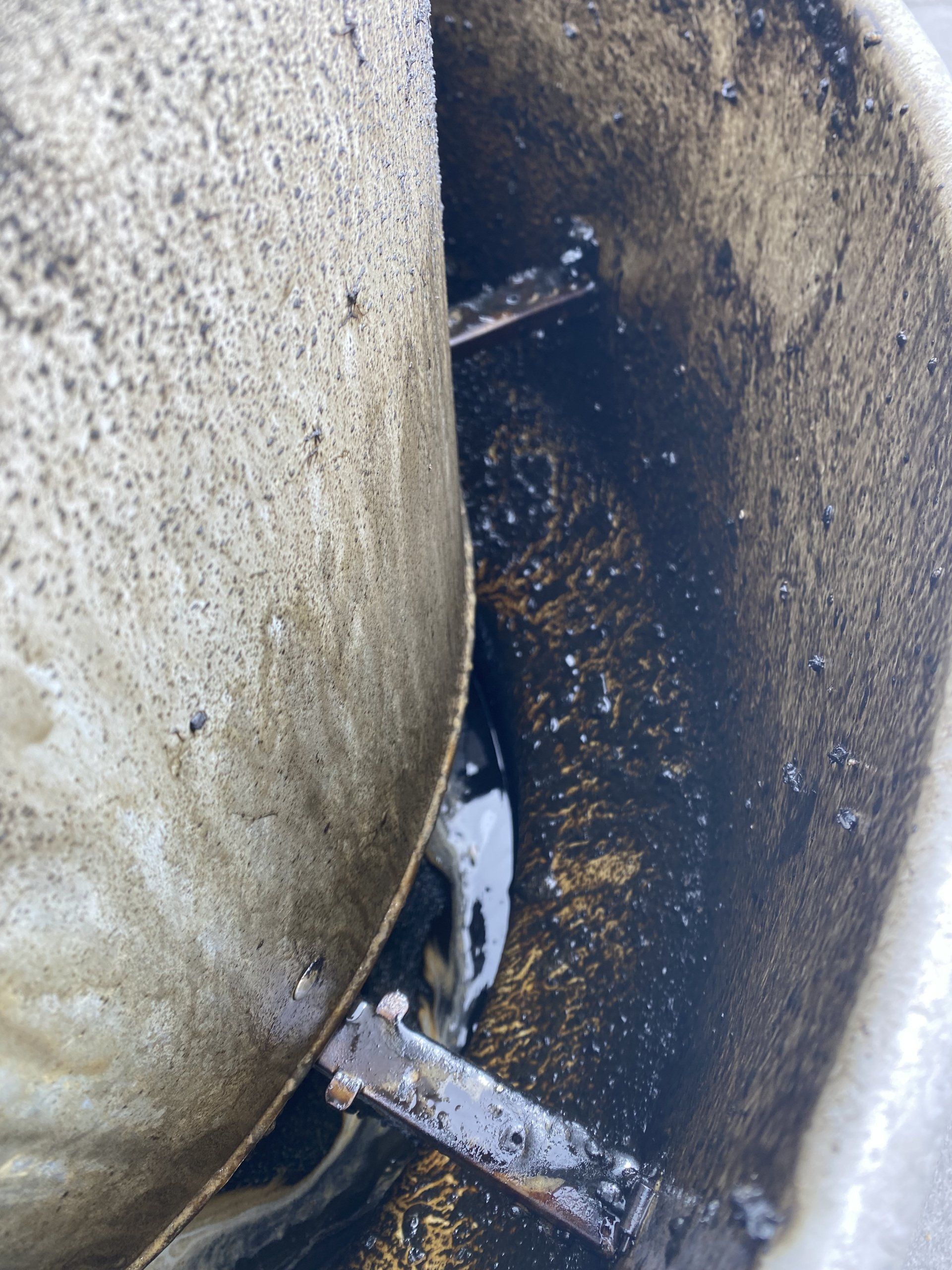 A close up of a metal object in a dirty area