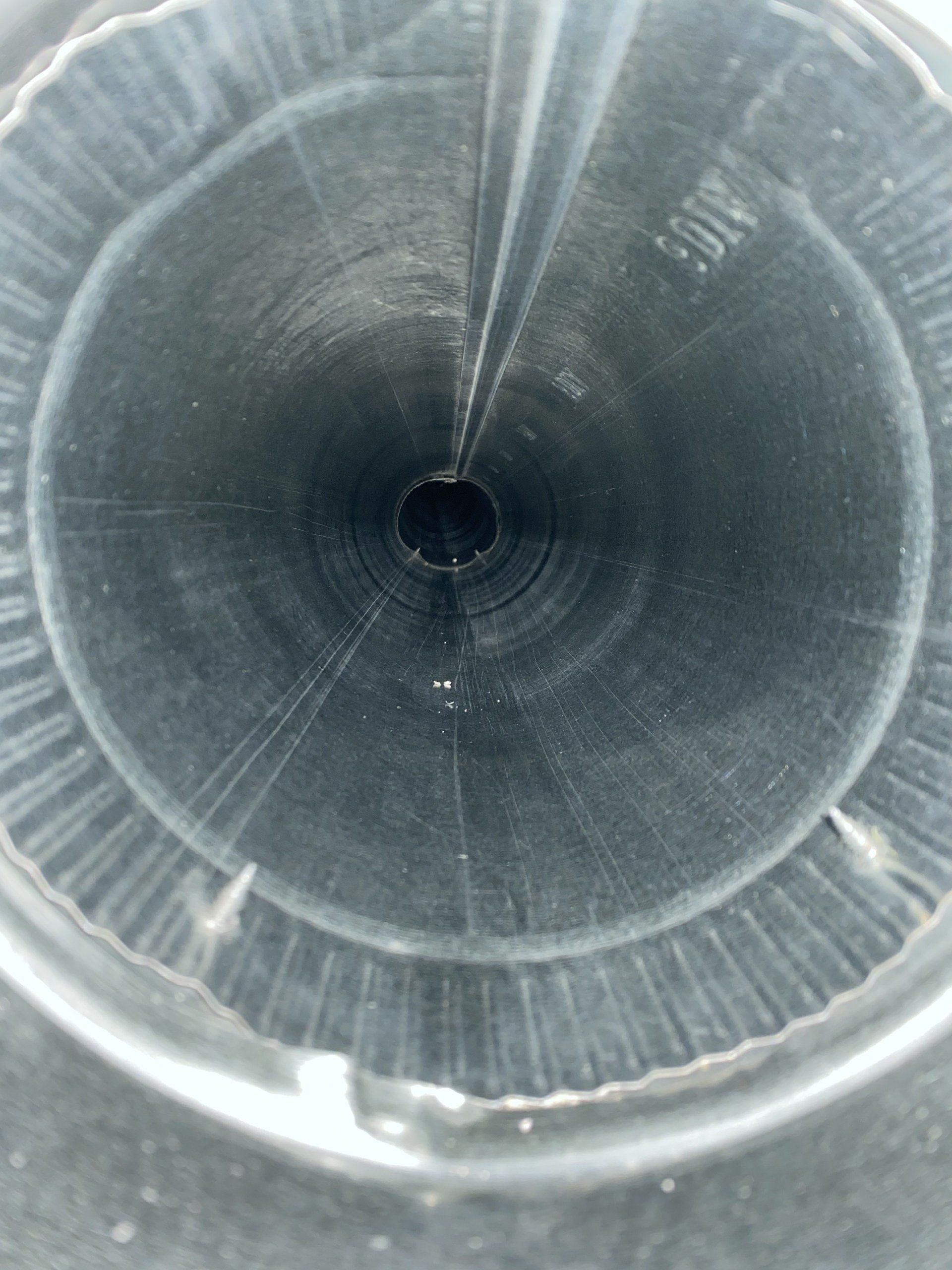 A close up of a metal pipe with a hole in the middle
