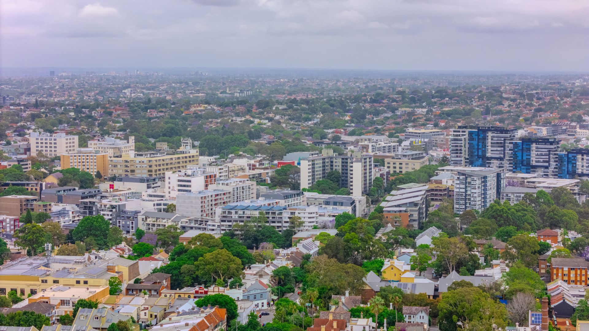 Cityscape With Buildings and Trees Under an Overcast Sky — Lifestyle Aluminium Lattice in Annandale, QLD