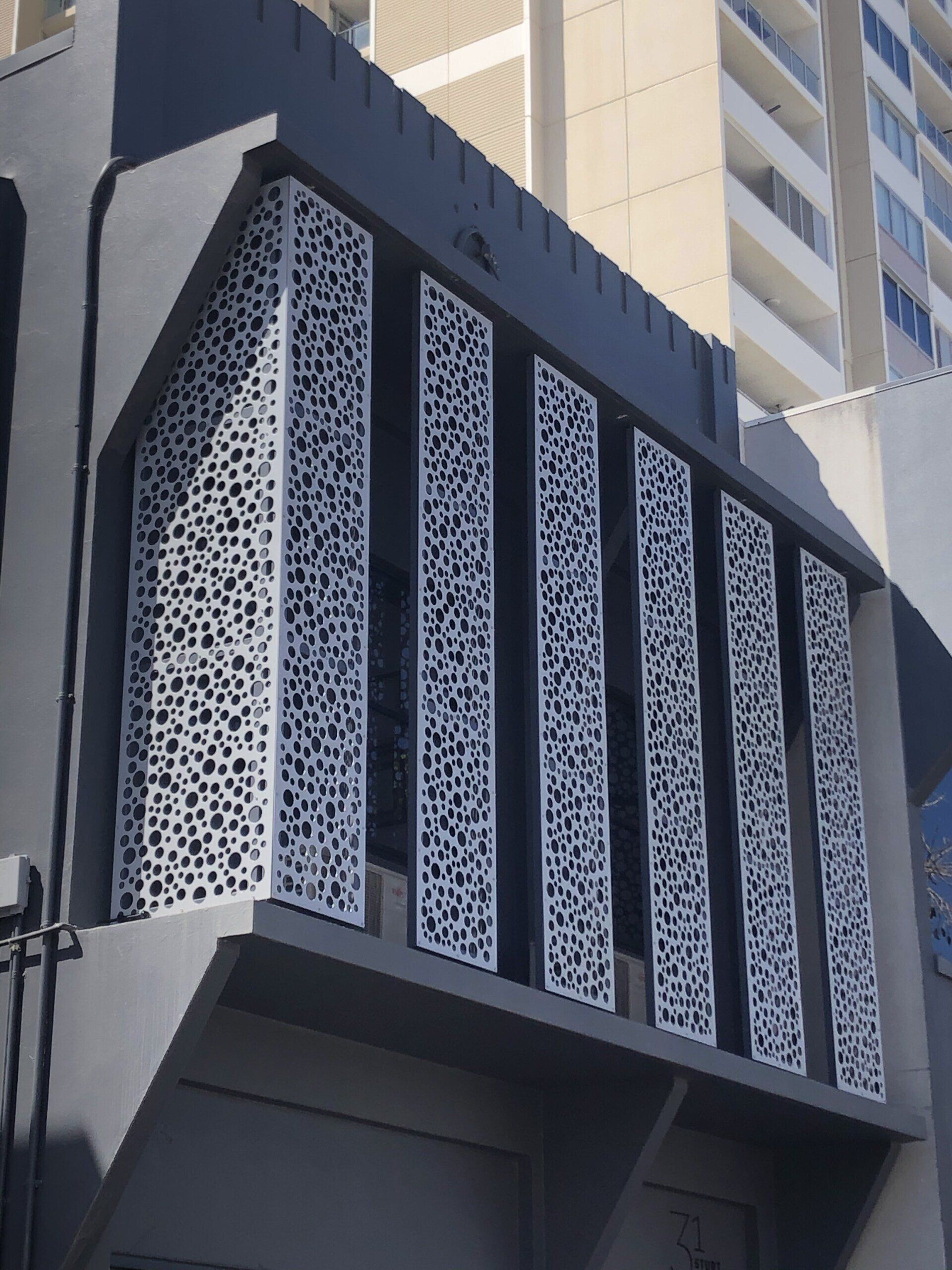 Exterior of a Gray Building With Decorative, Vertical, White Patterned Panels — Lifestyle Aluminium Lattice in West End, QLD