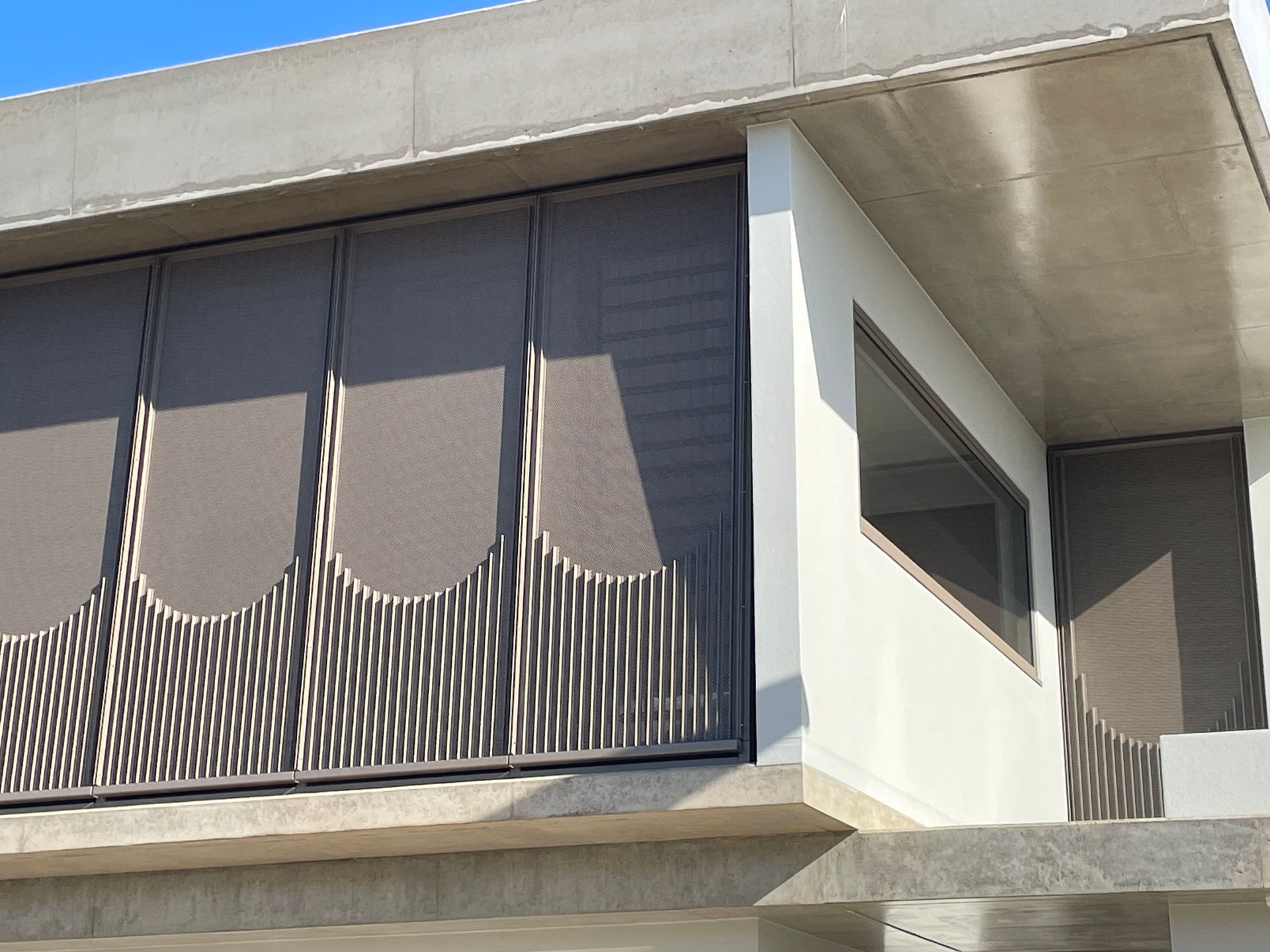 Gray mesh screens on a modern building's exterior, curved design — Lifestyle Aluminium Lattice in West End, QLD