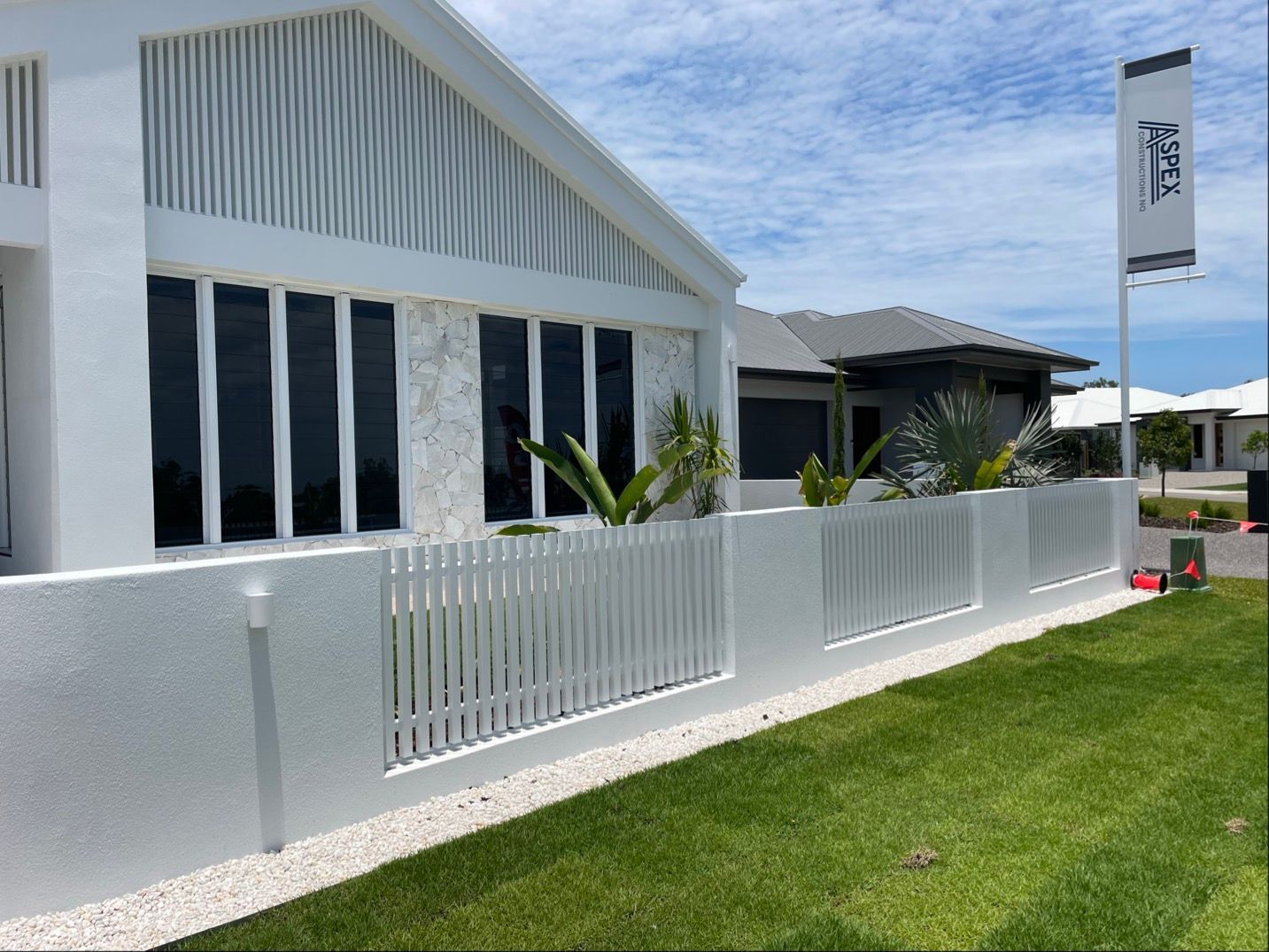White modern house with a white fence and green lawn on a sunny day — Lifestyle Aluminium Lattice in West End, QLD