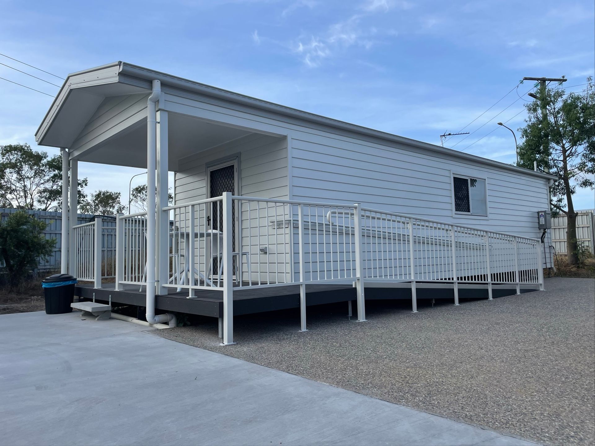 White modular building with a ramp and porch. Blue sky — Lifestyle Aluminium Lattice in West End, QLD