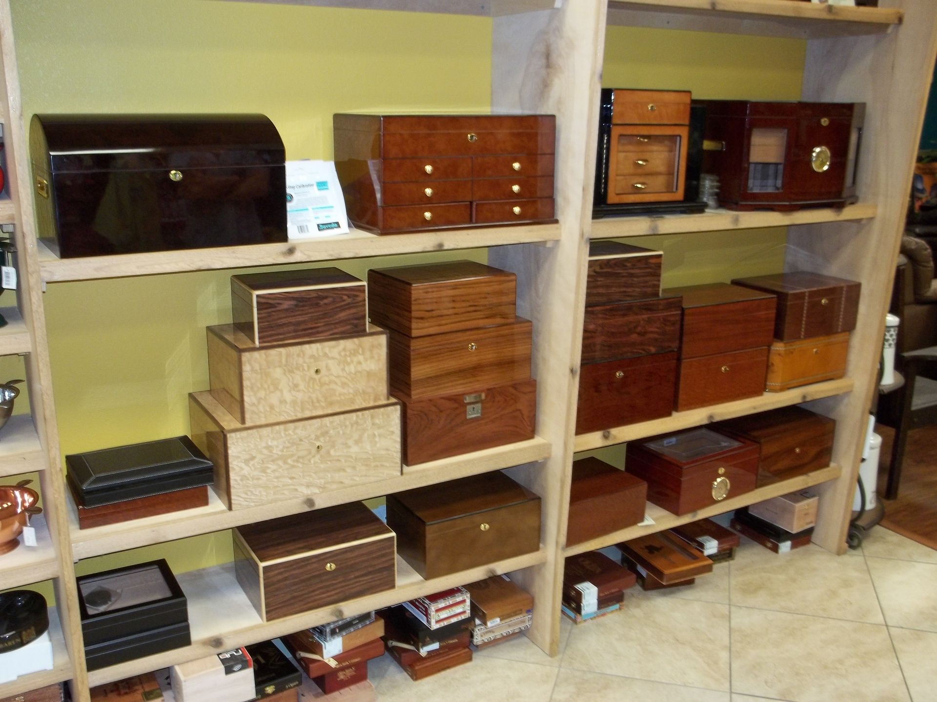 collection of cigar humidors on shelf