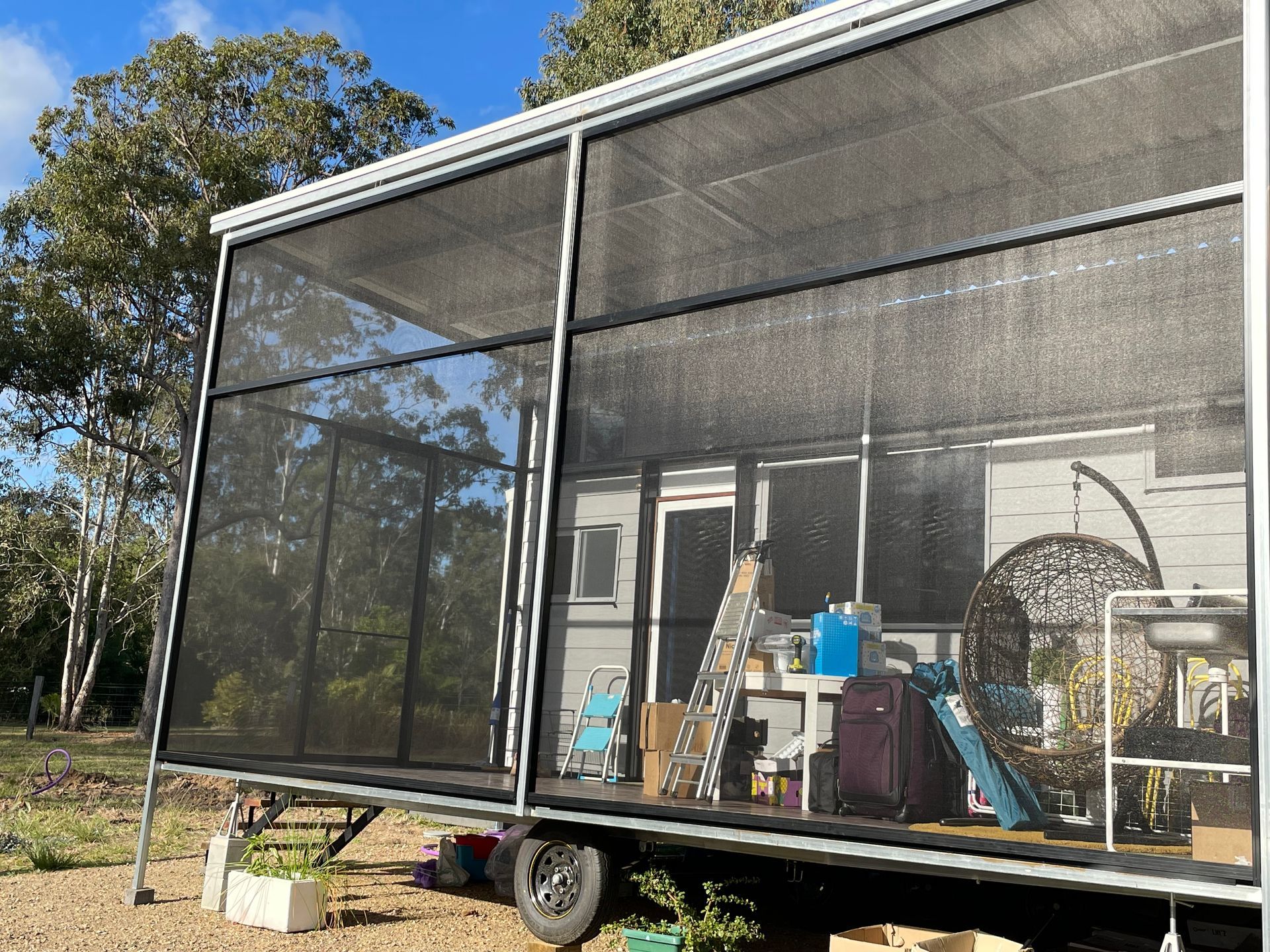 Screened patio enclosure on deck of tiny home