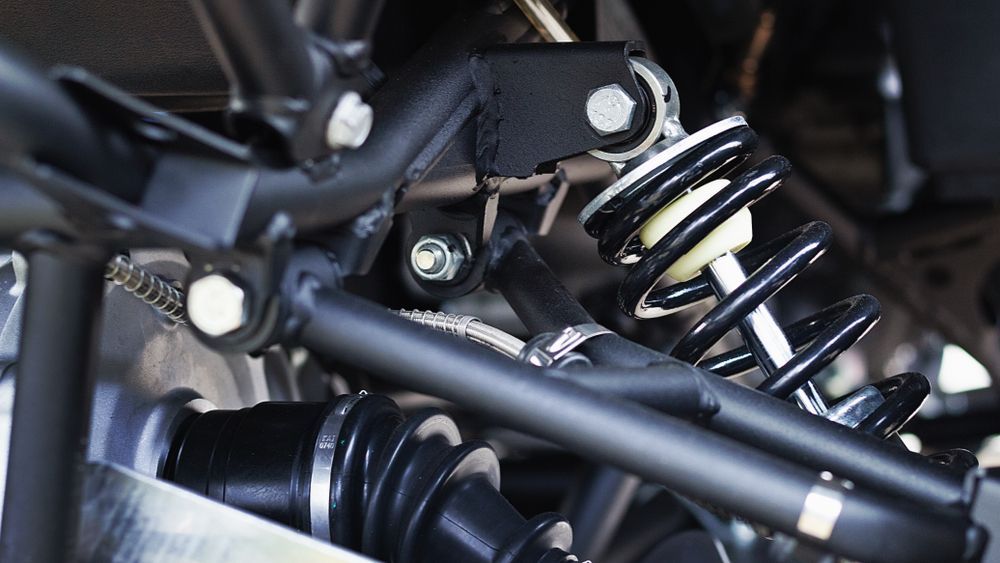 A close up of a shock absorber on a vehicle.