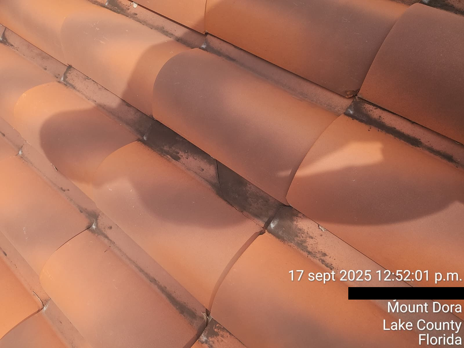 Close-up of weathered terracotta roof tiles with shadows. Located in Mount Dora, Florida.