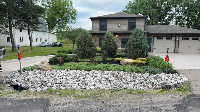 A house with a lot of rocks in front of it