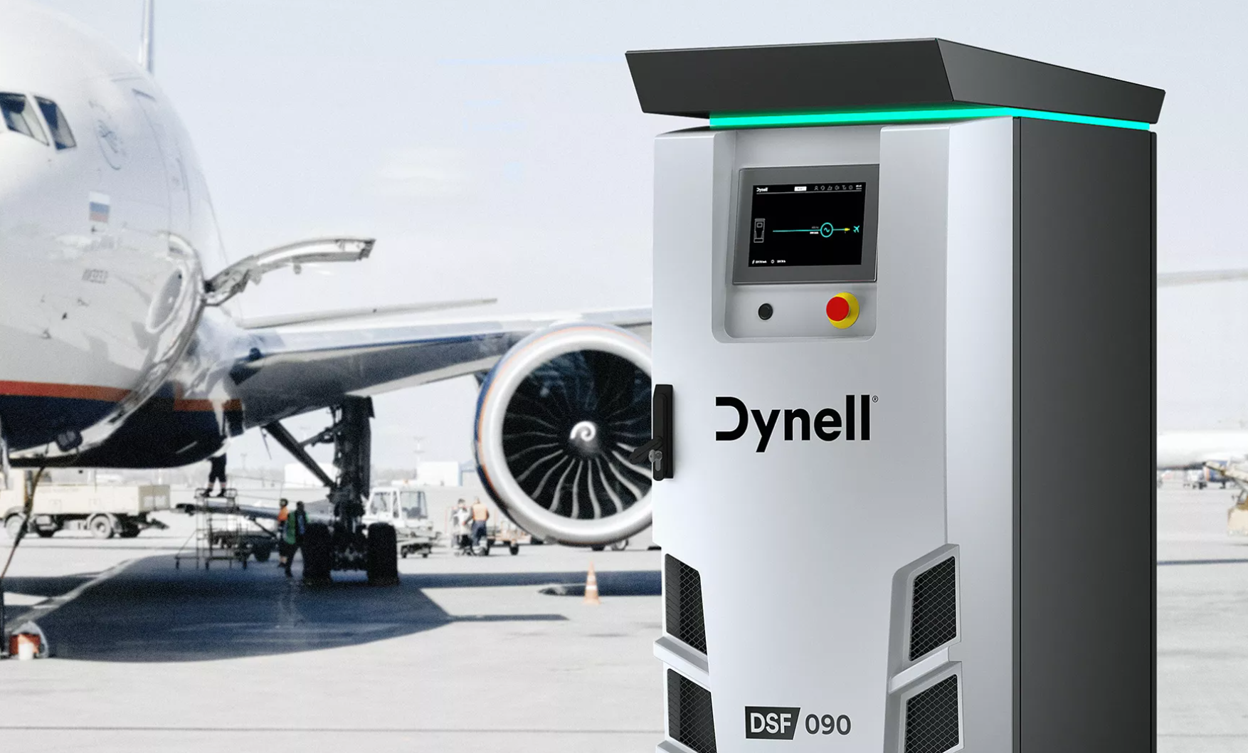 Un avion est garé devant une station de recharge Dynell.