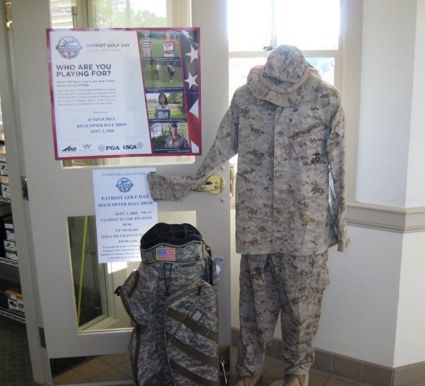 A mannequin in a military uniform stands in front of a sign that says 