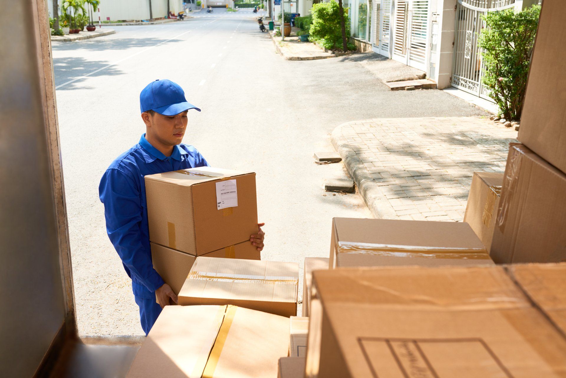 a man moving furniture boxes into a truck