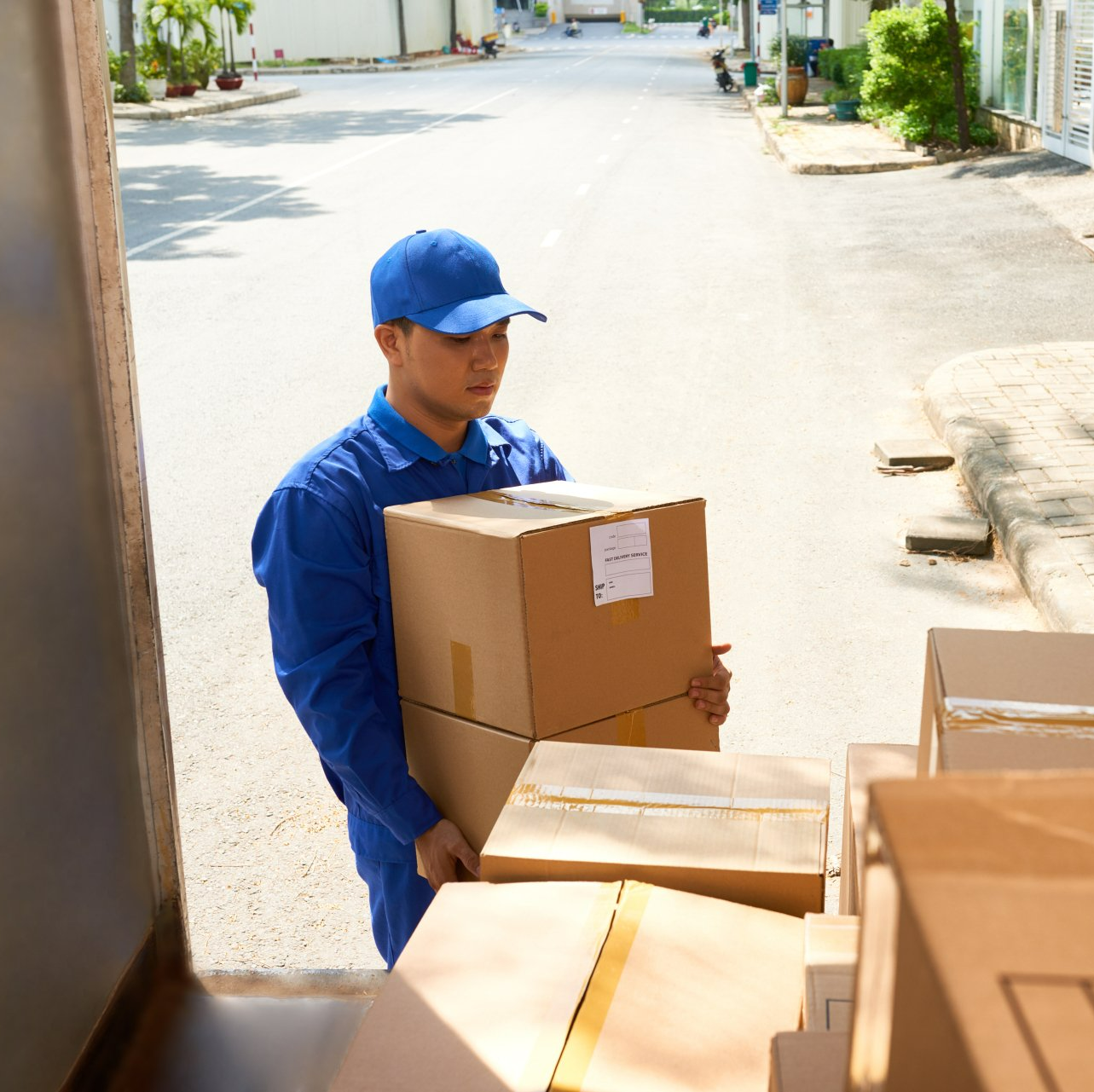 a man moving furniture boxes into a truck